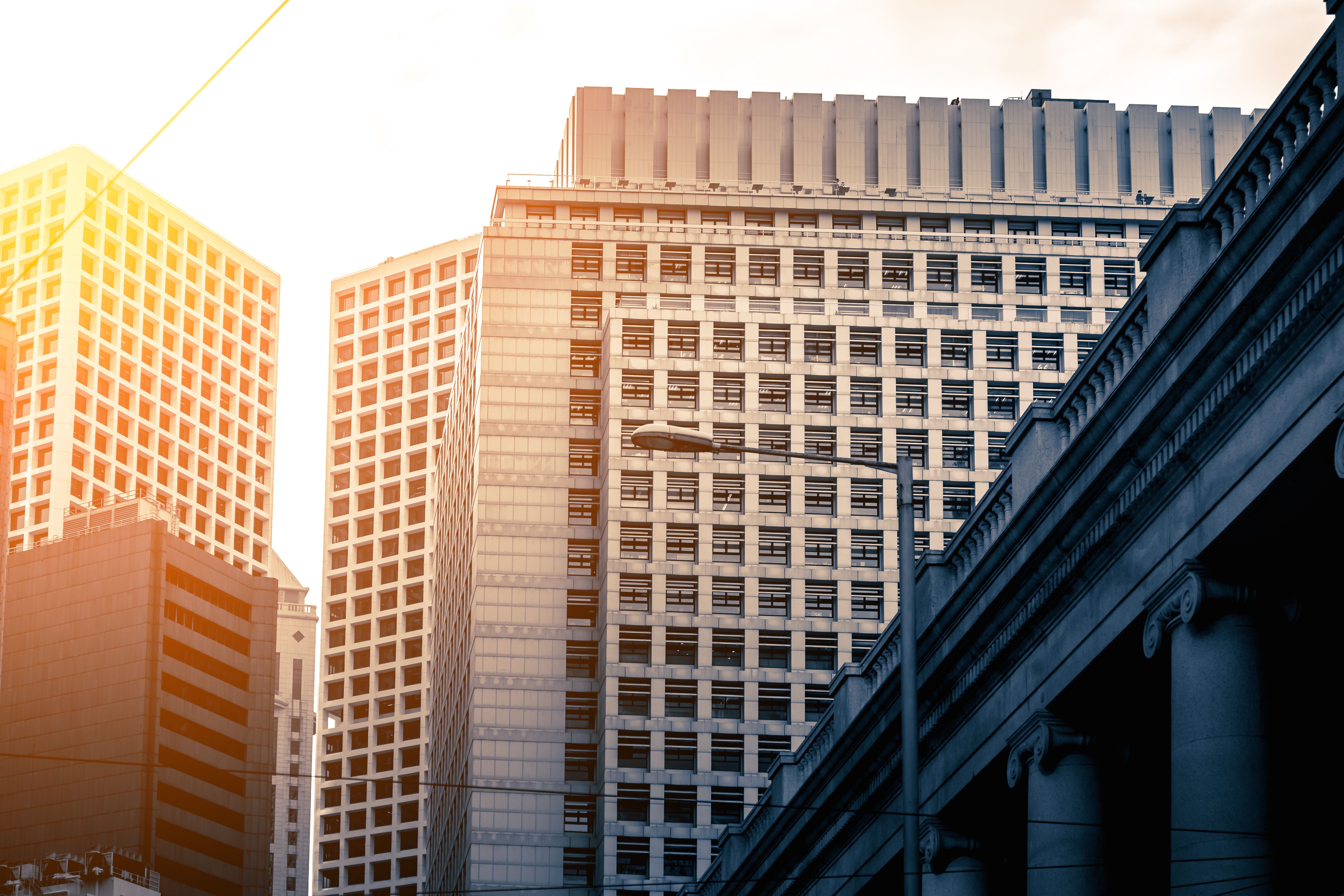 Commercial real estate buildings at sunrise, illustrating cap rate investment concepts.